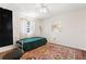 Bright bedroom featuring a single bed, large window and colorful rug at 1509 Coachlight Way, Dunedin, FL 34698