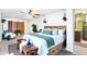 Well-lit bedroom featuring a comfortable bed, stylish lighting, and natural accents at 1509 Coachlight Way, Dunedin, FL 34698