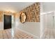 Bright and inviting foyer showcasing stylish wallpaper, decorative wall mirror, and tile flooring at 1509 Coachlight Way, Dunedin, FL 34698