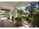 Inviting covered front porch with a landscaped yard, beautiful stone path, and a well-maintained walkway at 1509 Coachlight Way, Dunedin, FL 34698