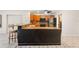 Well-equipped kitchen boasting wooden cabinets, stainless steel appliances, and a convenient breakfast bar at 1509 Coachlight Way, Dunedin, FL 34698