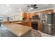 Well-equipped kitchen boasting wooden cabinets, stainless steel appliances, and a convenient breakfast bar at 1509 Coachlight Way, Dunedin, FL 34698