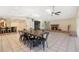 Bright living room with tile floors, brick fireplace, skylights, ceiling fans, and dining table and bar at 1509 Coachlight Way, Dunedin, FL 34698
