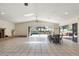 Open living room with tile floors, fireplace, and seamless access to the screened pool area at 1509 Coachlight Way, Dunedin, FL 34698
