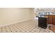 An open-concept living space featuring tile floors and a breakfast bar, flowing through to the kitchen at 1509 Coachlight Way, Dunedin, FL 34698