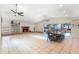 Bright living room with tile floors, brick fireplace, skylights, ceiling fans, dining table and access to the pool at 1509 Coachlight Way, Dunedin, FL 34698