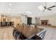 Bright living room with tile floors, brick fireplace, skylights, ceiling fans, and dining table and bar at 1509 Coachlight Way, Dunedin, FL 34698