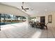 Open-concept living area with tile floors seamlessly connects to the screened pool and outdoor space at 1509 Coachlight Way, Dunedin, FL 34698