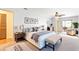 Bright main bedroom with a king bed, sitting area, and access to an outdoor spa at 1509 Coachlight Way, Dunedin, FL 34698