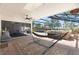 Screened in pool and hot tub with brick deck and covered seating area at 1509 Coachlight Way, Dunedin, FL 34698