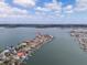 Expansive aerial view of a waterfront community, featuring beautiful homes with boat docks and serene water views at 16496 Redington Dr, Redington Beach, FL 33708