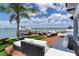 Luxury backyard features a stylish patio, boat lift, and waterfront views, perfect for outdoor entertaining and relaxation at 16496 Redington Dr, Redington Beach, FL 33708