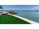 Waterfront backyard with boat lift provides direct access to the water, ideal for boating enthusiasts at 16496 Redington Dr, Redington Beach, FL 33708