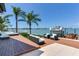 This backyard has stylish seating, a boat lift and direct water access offering a luxurious waterfront lifestyle at 16496 Redington Dr, Redington Beach, FL 33708