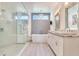 Bright bathroom featuring a modern tub, sleek vanity with dual sinks, and a glass-enclosed shower at 16496 Redington Dr, Redington Beach, FL 33708