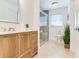 Well-lit bathroom with a wood vanity, a shower, and a toilet at 16496 Redington Dr, Redington Beach, FL 33708