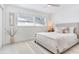 Serene bedroom with neutral tones, a comfortable bed, and natural light from the window at 16496 Redington Dr, Redington Beach, FL 33708