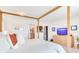 Bright primary bedroom with a wooden canopy bed, walk-in closet, and adjacent bathroom at 16496 Redington Dr, Redington Beach, FL 33708