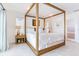 White bedroom featuring wooden canopy bed frame, light walls, and neutral-toned accents at 16496 Redington Dr, Redington Beach, FL 33708