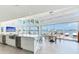 A stylish dining area offers water views, a modern table set, and access to outdoor amenities at 16496 Redington Dr, Redington Beach, FL 33708