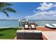 Waterfront property featuring a private dock with boat lift, seating area, and stunning views at 16496 Redington Dr, Redington Beach, FL 33708