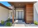 Inviting home entryway featuring modern design elements, stone landscaping, and a covered porch at 16496 Redington Dr, Redington Beach, FL 33708