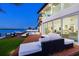 Elegant waterfront home with large windows, a waterfront pool, and outdoor lounge areas with stunning views at 16496 Redington Dr, Redington Beach, FL 33708