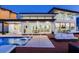 Contemporary waterfront home featuring an outdoor pool, spacious deck, and floor-to-ceiling windows with waterfront views at 16496 Redington Dr, Redington Beach, FL 33708