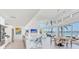 Bright kitchen and dining area featuring a marble island, stainless steel appliances, and water views at 16496 Redington Dr, Redington Beach, FL 33708