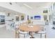 Gourmet kitchen and dining area with marble island, stainless steel appliances, and waterfront views at 16496 Redington Dr, Redington Beach, FL 33708