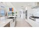 Bright kitchen with white cabinetry, stainless steel appliances, and marble countertops overlooking waterfront at 16496 Redington Dr, Redington Beach, FL 33708