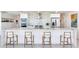 A modern kitchen features a breakfast bar with seating, stainless steel appliances and contemporary design at 16496 Redington Dr, Redington Beach, FL 33708