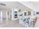 Kitchen with white cabinets, stainless steel appliances, and a marble countertop island with seating at 16496 Redington Dr, Redington Beach, FL 33708
