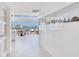 Sleek kitchen with white cabinetry, a large island, and stunning waterfront views at 16496 Redington Dr, Redington Beach, FL 33708