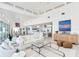 Spacious living room showcasing an open-concept design leading to a modern kitchen and dining area at 16496 Redington Dr, Redington Beach, FL 33708