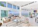 Bright, open living room with floor-to-ceiling windows offering panoramic waterfront views at 16496 Redington Dr, Redington Beach, FL 33708