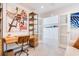 Bright office area features a modern wood desk with metal frame and stylish shelving unit with artistic decor at 16496 Redington Dr, Redington Beach, FL 33708