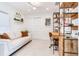 Cozy home office with a comfortable couch, desk and ample storage at 16496 Redington Dr, Redington Beach, FL 33708
