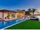 Luxurious waterfront property with a sparkling pool, outdoor dining, and a private dock for boating enthusiasts at 16496 Redington Dr, Redington Beach, FL 33708