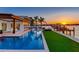 Stunning waterfront home with a luxurious pool and dock overlooking a beautiful sunset view at 16496 Redington Dr, Redington Beach, FL 33708