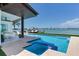 Outdoor pool and waterfront views create a serene and luxurious backyard setting at 16496 Redington Dr, Redington Beach, FL 33708