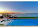 Beautiful waterfront home with a pool, lounge chairs, and a private boat dock perfect for enjoying the sunset at 16496 Redington Dr, Redington Beach, FL 33708