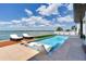 This backyard has a pool, waterfront access, and lounge chairs perfect for a waterfront oasis at 16496 Redington Dr, Redington Beach, FL 33708