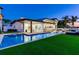 Gorgeous waterfront property featuring a sparkling pool, lush landscaping, and outdoor seating for relaxation and entertaining at 16496 Redington Dr, Redington Beach, FL 33708