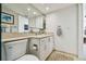 White bathroom features a vanity with a sink and toilet at 1750 Benjamin Franklin Dr # 11G, Sarasota, FL 34236
