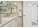 Bathroom boasts a marble countertop vanity and an adjoining shower at 1750 Benjamin Franklin Dr # 11G, Sarasota, FL 34236