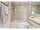 Bathroom boasts a glass-enclosed tiled shower with a showerhead and a tub at 1750 Benjamin Franklin Dr # 11G, Sarasota, FL 34236