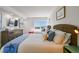 Bedroom features two beds with colorful pillows, beach-themed decor, and a window view at 1750 Benjamin Franklin Dr # 11G, Sarasota, FL 34236