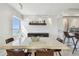 Bright dining room featuring a modern table, floating shelf, and sleek cabinets, perfect for entertaining guests at 1750 Benjamin Franklin Dr # 11G, Sarasota, FL 34236