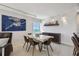 Dining area with a large table, modern lighting, and ocean view at 1750 Benjamin Franklin Dr # 11G, Sarasota, FL 34236